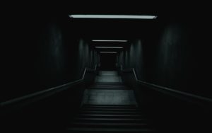 Spooky stairs leading into a dark basement.